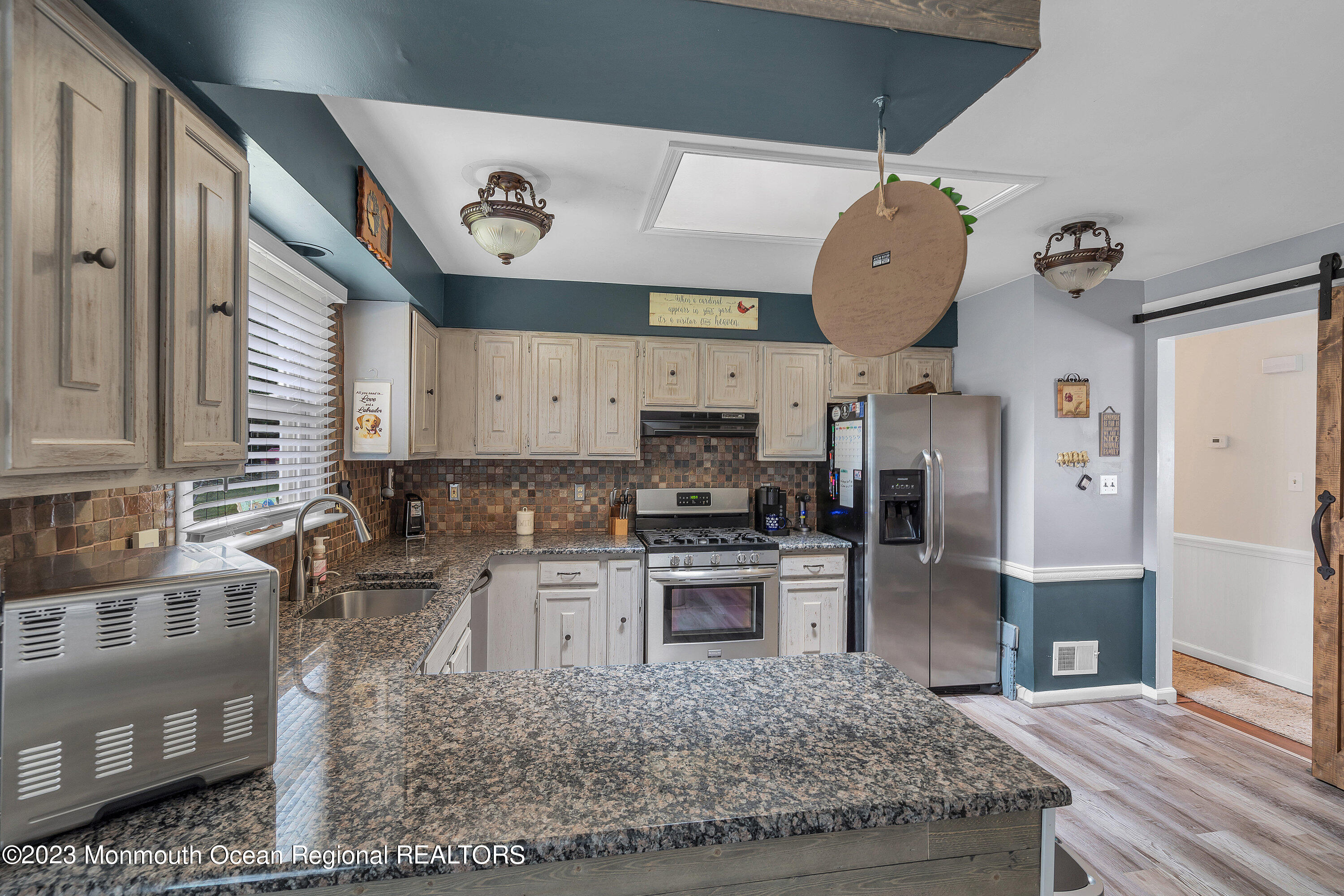 20 Woodland Road Bayville, NJ 08721 - Photo 33 of 62 a kitchen with stainless steel appliances granite countertop a sink a stove and a wooden floors