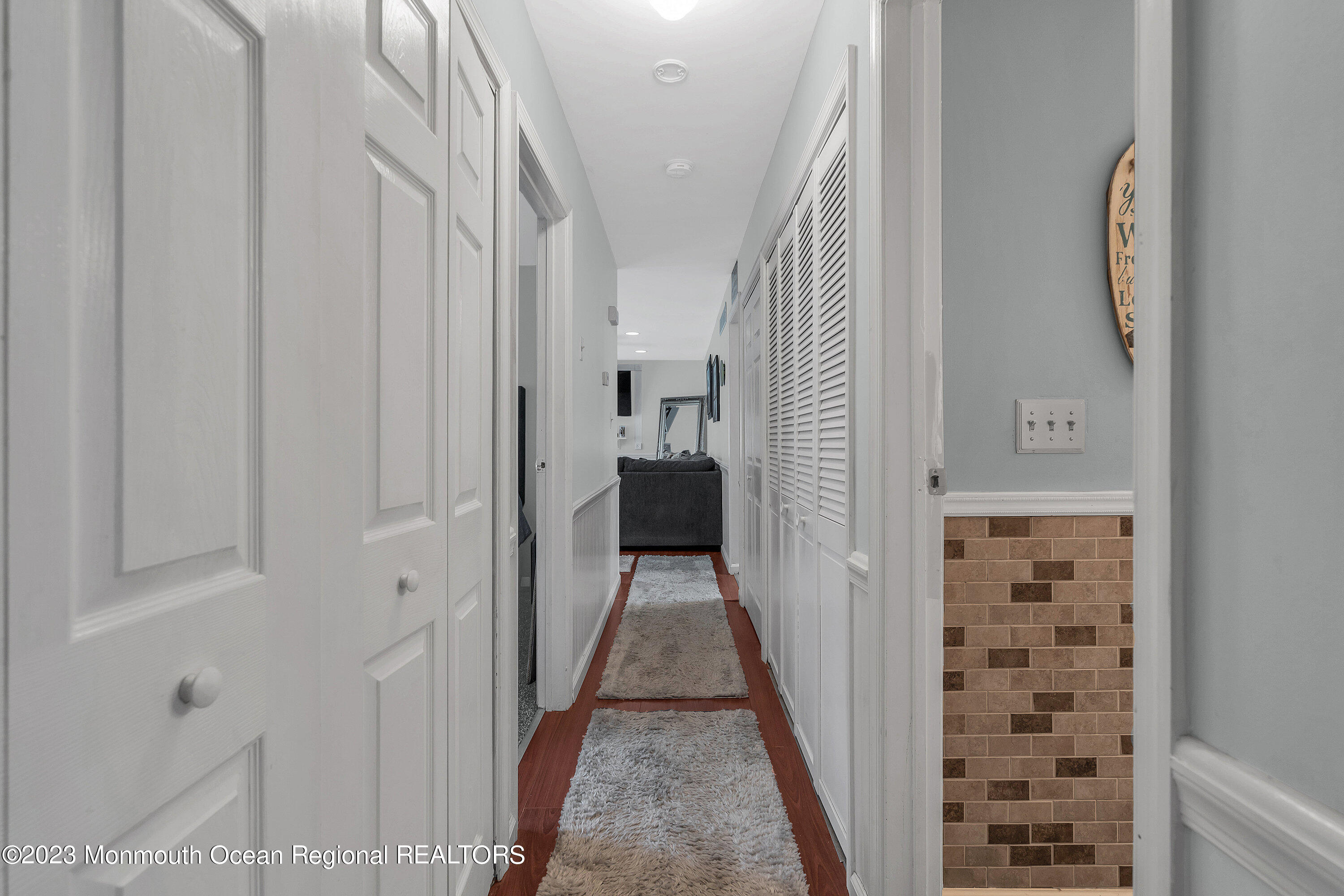 20 Woodland Road Bayville, NJ 08721 - Photo 38 of 62 a view of a hallway with windows and stairs