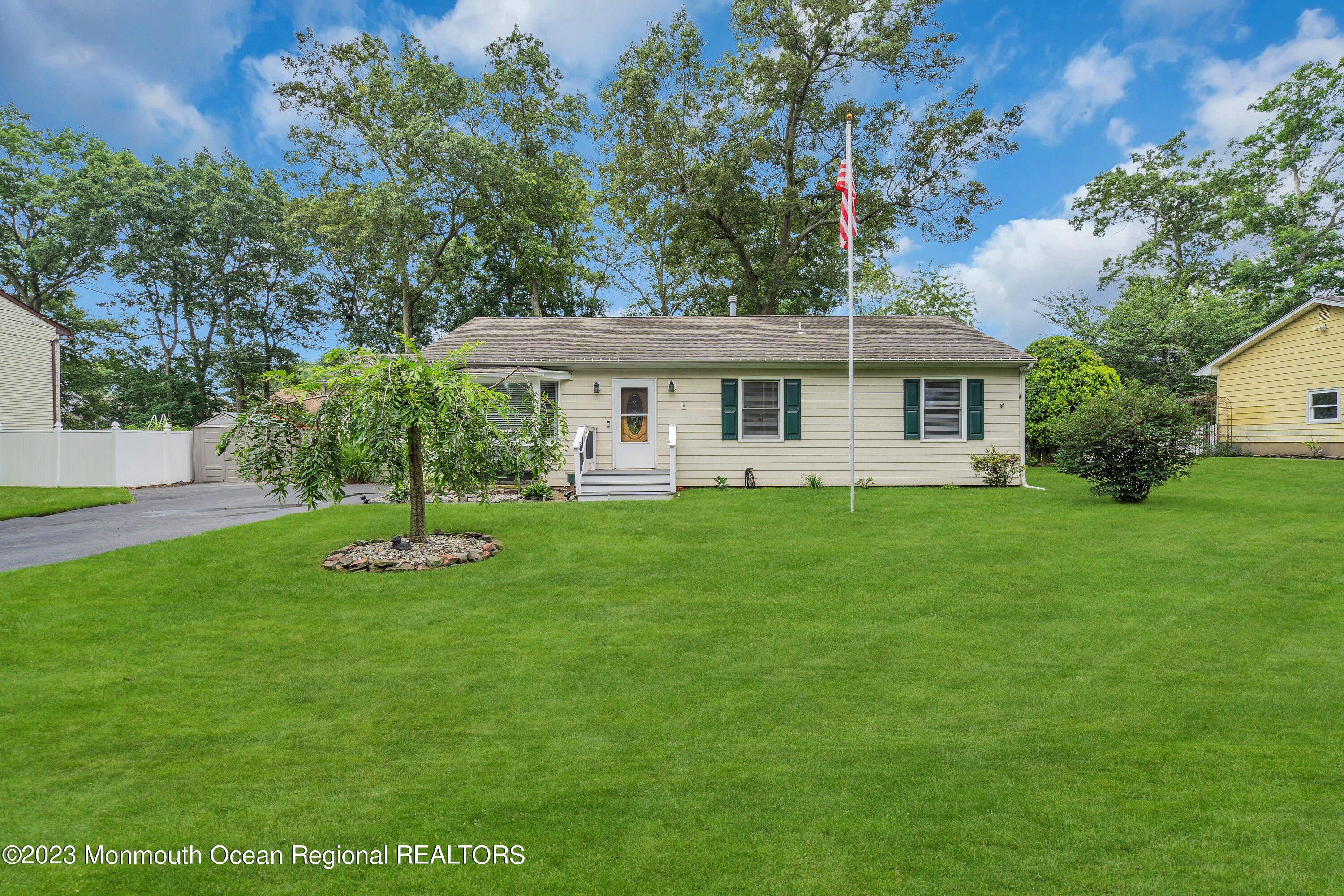 20 Woodland Road Bayville, NJ 08721 - Photo 4 of 62 a front view of house with a garden and trees