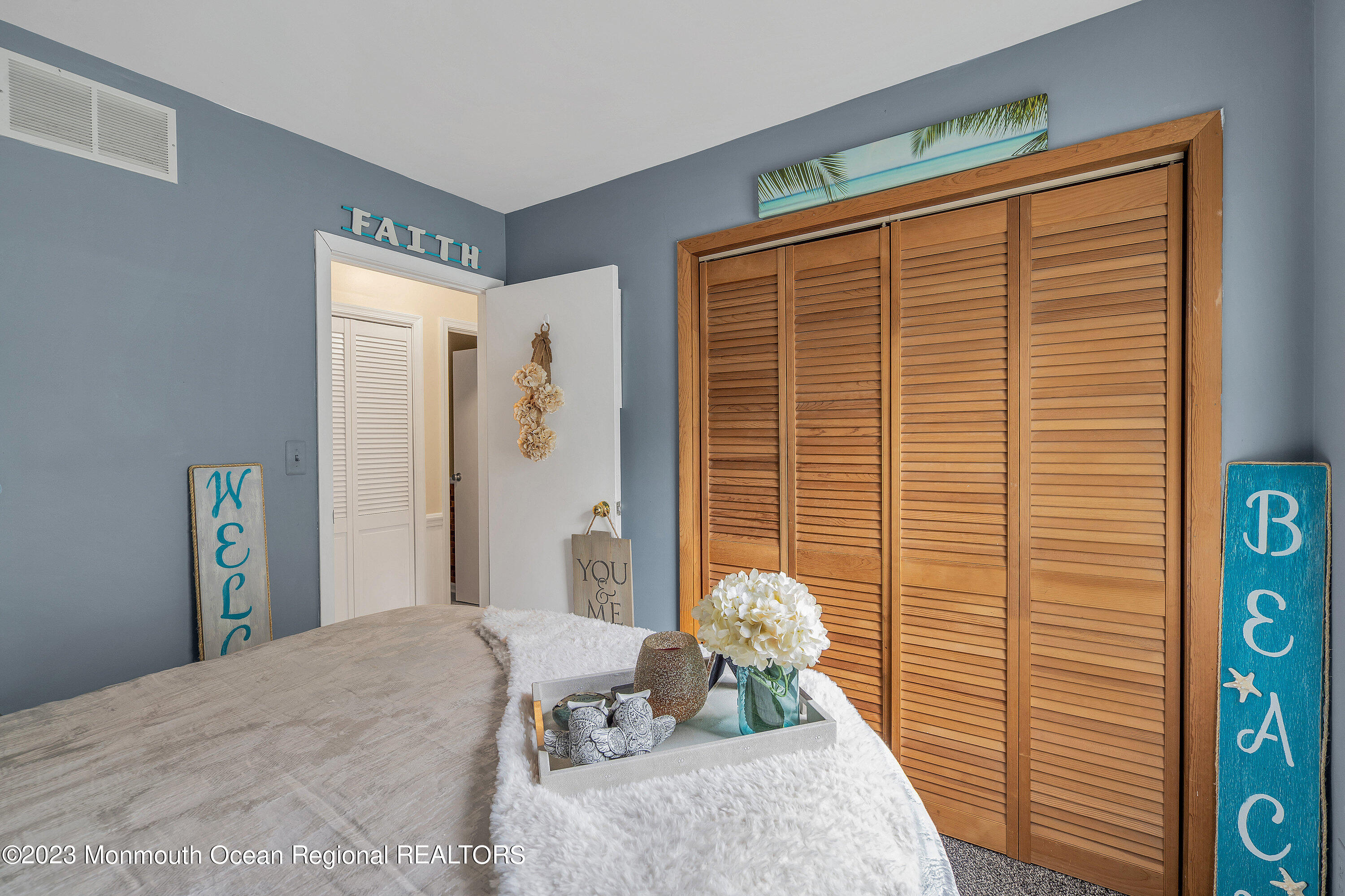 20 Woodland Road Bayville, NJ 08721 - Photo 41 of 62 a bedroom with a bed and wooden floor