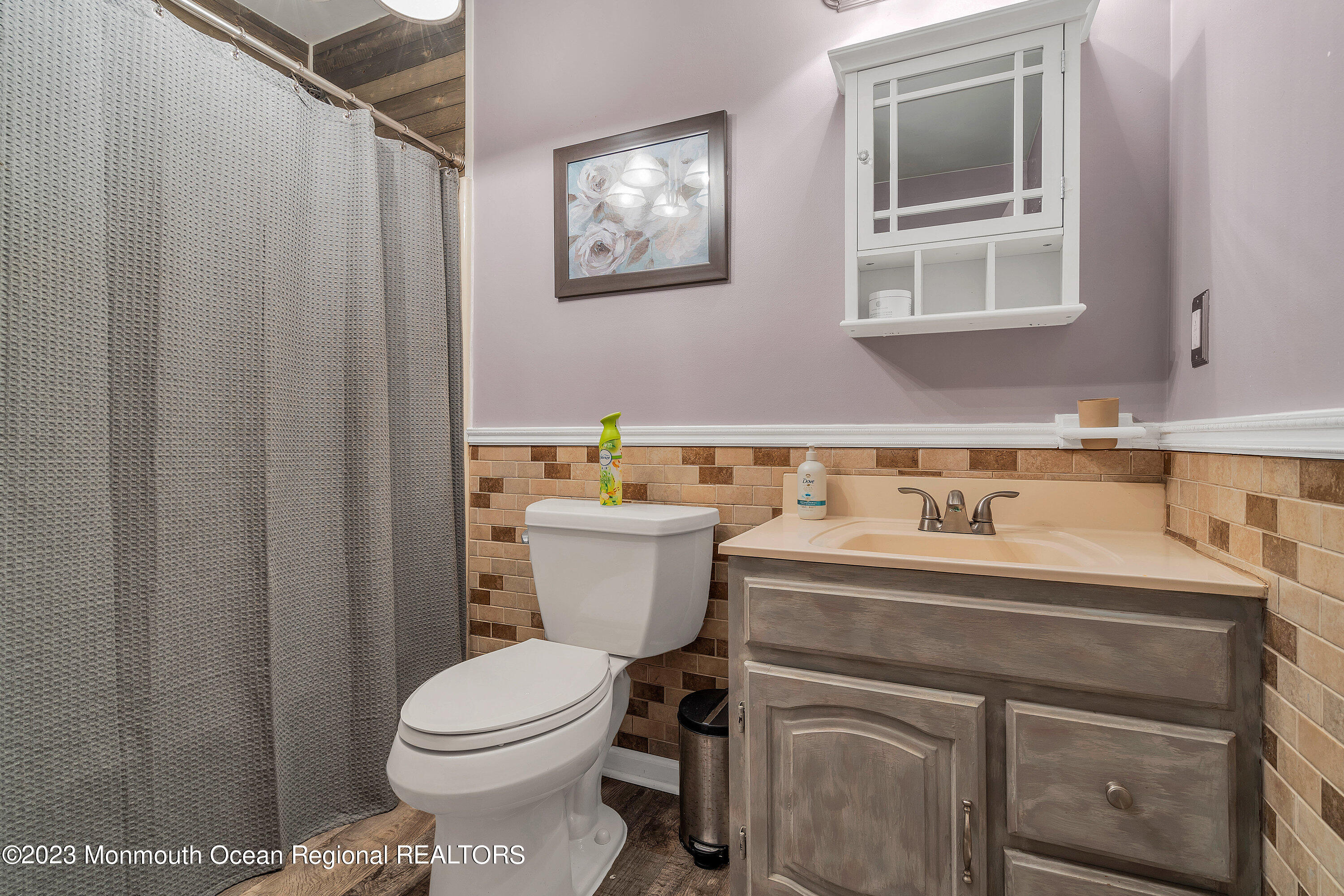 20 Woodland Road Bayville, NJ 08721 - Photo 42 of 62 a bathroom with a sink a toilet and a mirror