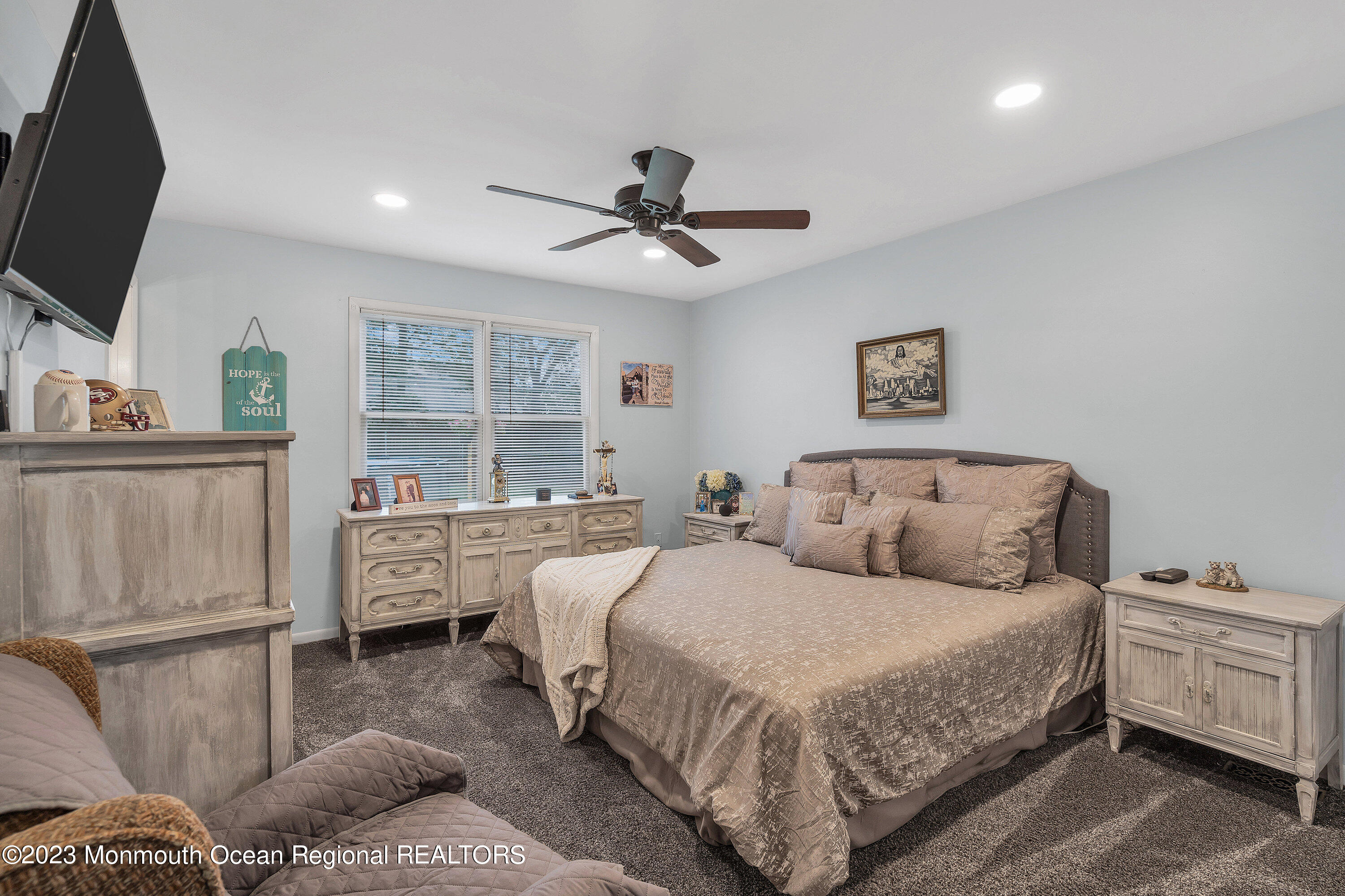 20 Woodland Road Bayville, NJ 08721 - Photo 44 of 62 a spacious bedroom with a bed and a flat screen tv
