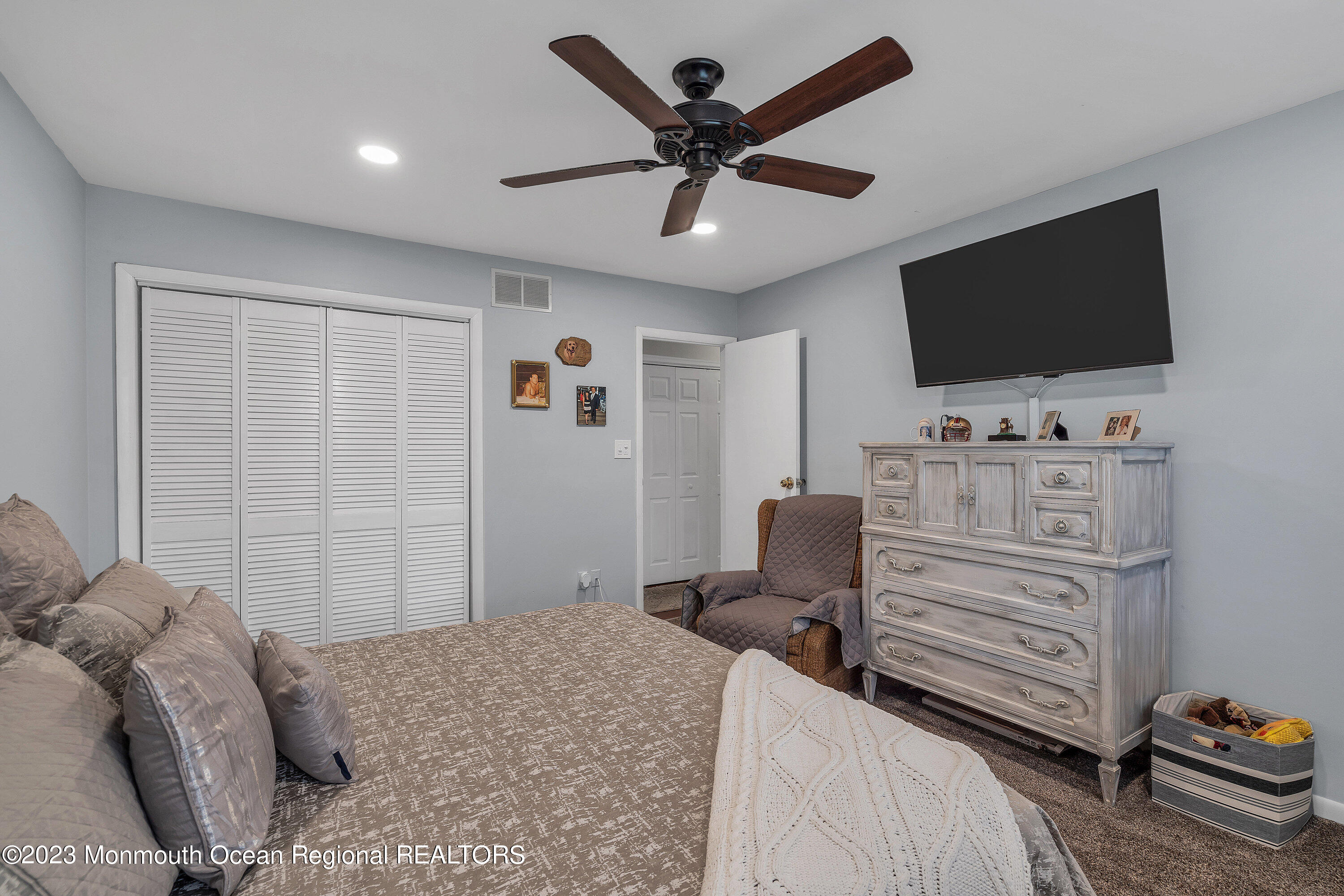 20 Woodland Road Bayville, NJ 08721 - Photo 45 of 62 a bedroom with a bed and a flat screen tv