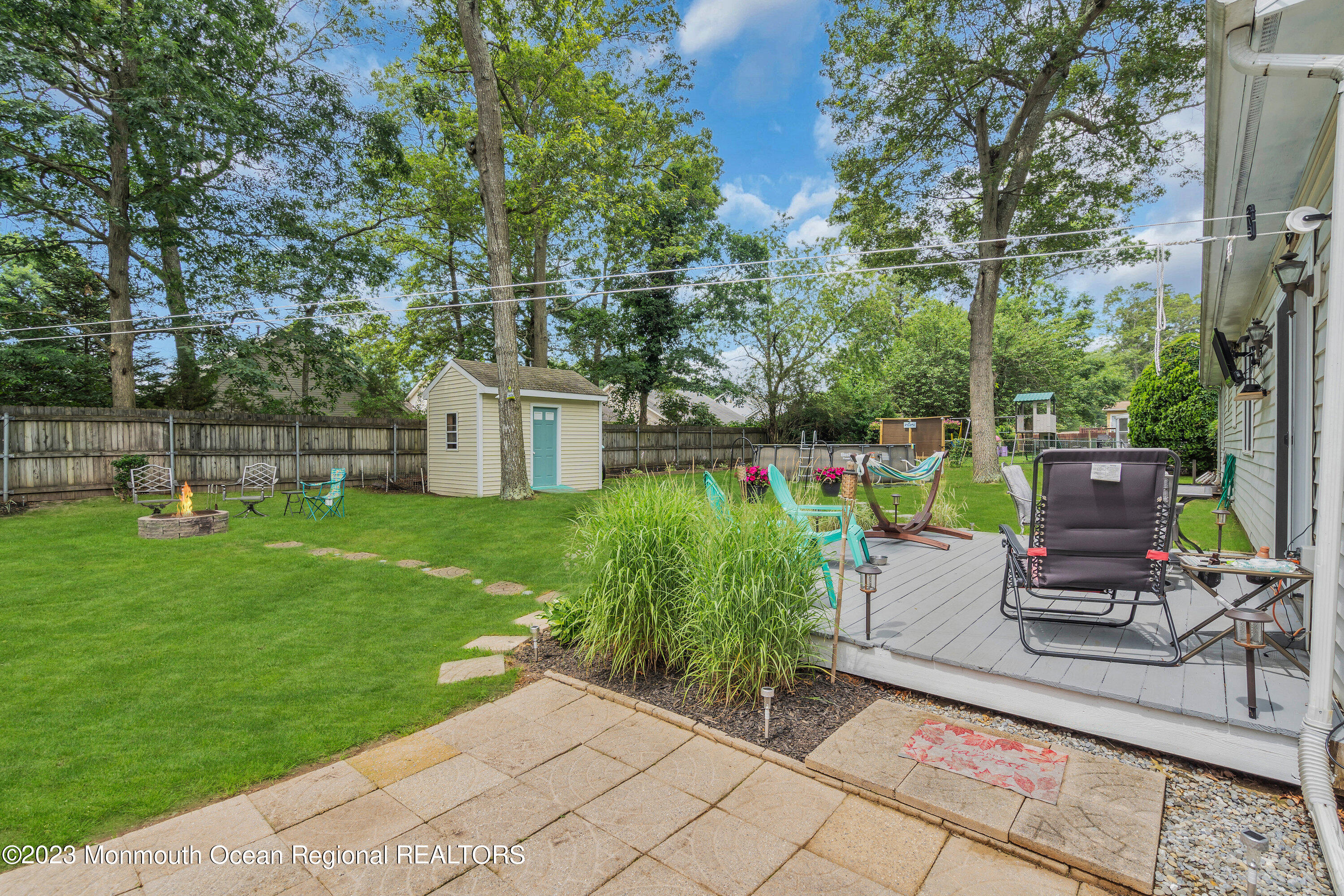 20 Woodland Road Bayville, NJ 08721 - Photo 58 of 62 a view of a chair and table in the garden