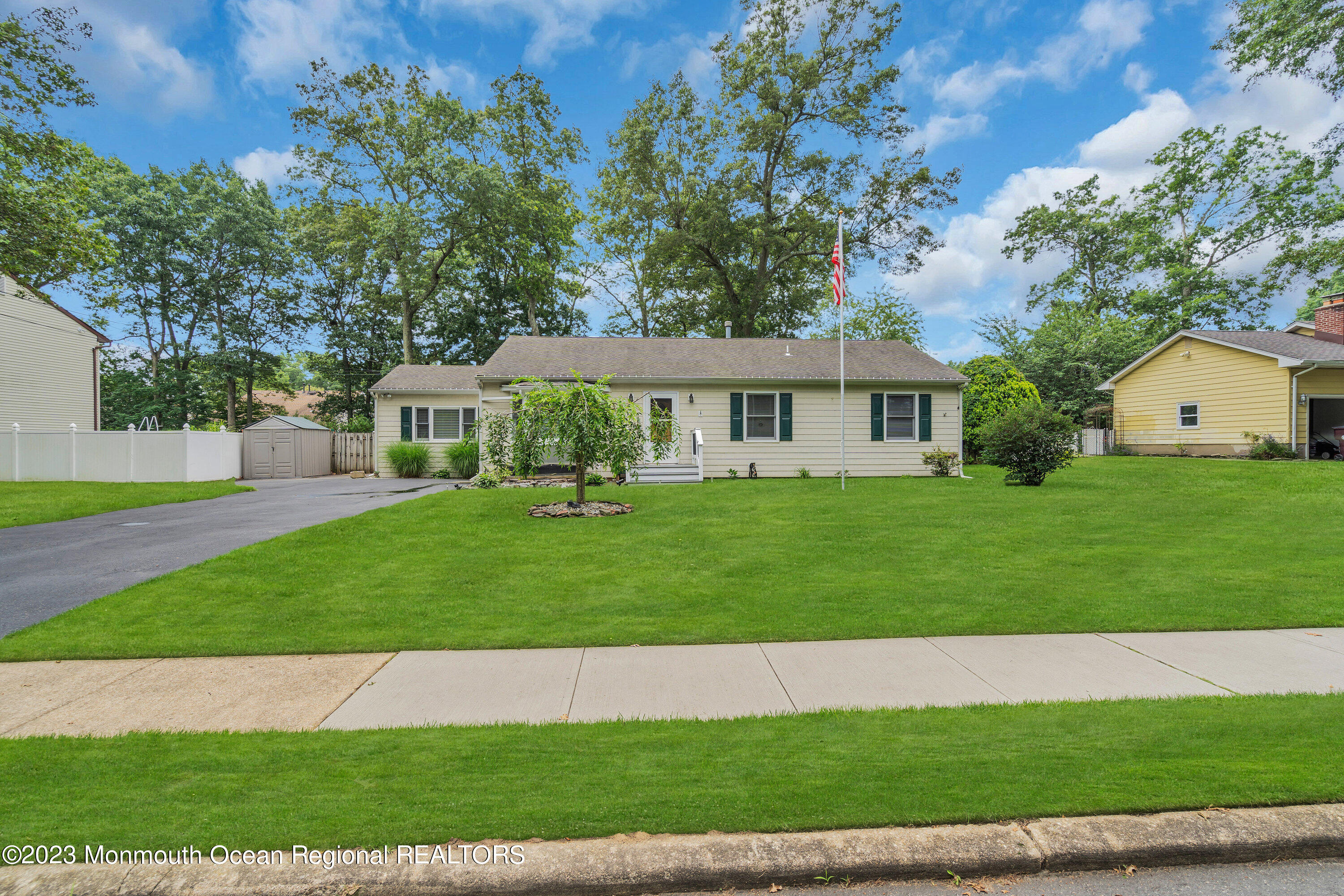 20 Woodland Road Bayville, NJ 08721 - Photo 7 of 62 a front view of a house with a garden and yard