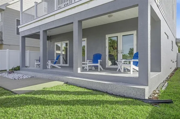 a view of a porch with furniture and garden
