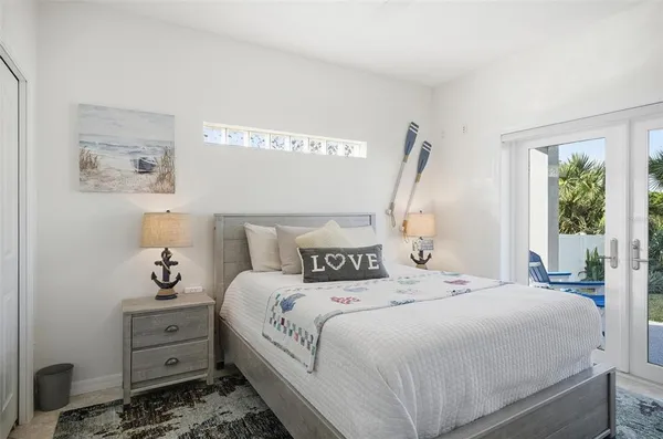 a bedroom with a bed and a mirror