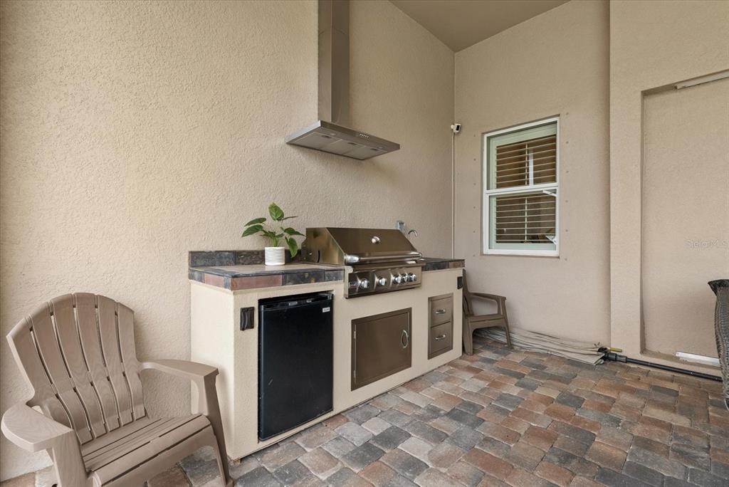 12423 Blue Hl Trail Lakewood Ranch, FL 34211 - Photo 35 of 74 a kitchen with a stove and a refrigerator