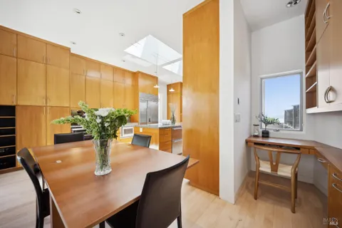 a view of a dining room with furniture and a potted plant