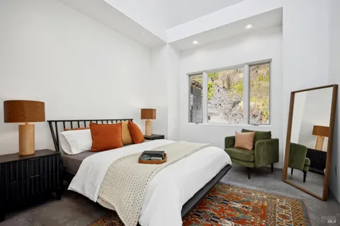 a bed room with a bed and a chair