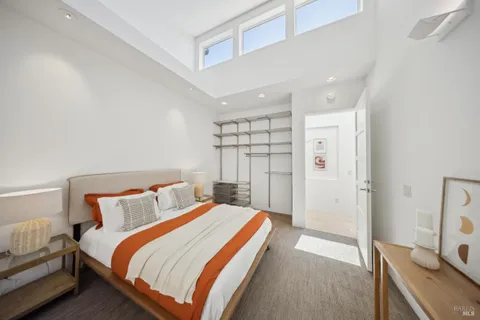 a bedroom with a bed and a desk