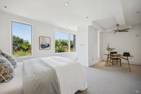 a bedroom with a bed and a painting on the wall