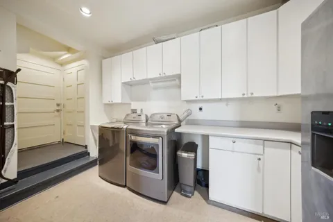a kitchen with granite countertop white cabinets and white appliances