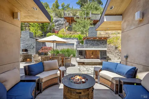 a outdoor space with patio fireplace and a potted plant