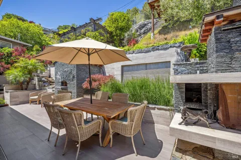 a view of an outdoor dining space with a patio and furniture
