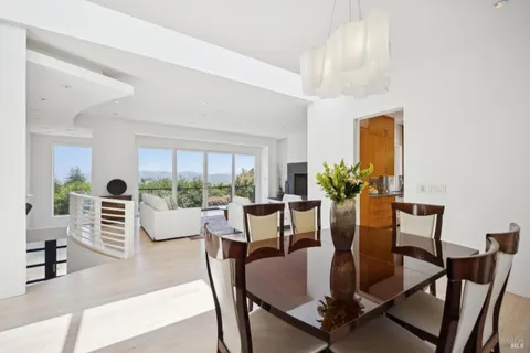 a view of a dining room with furniture large windows and wooden floor