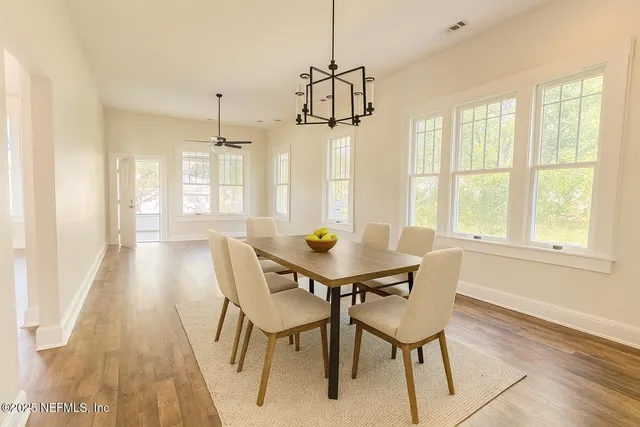a view of a dining room with furniture window and wooden floor