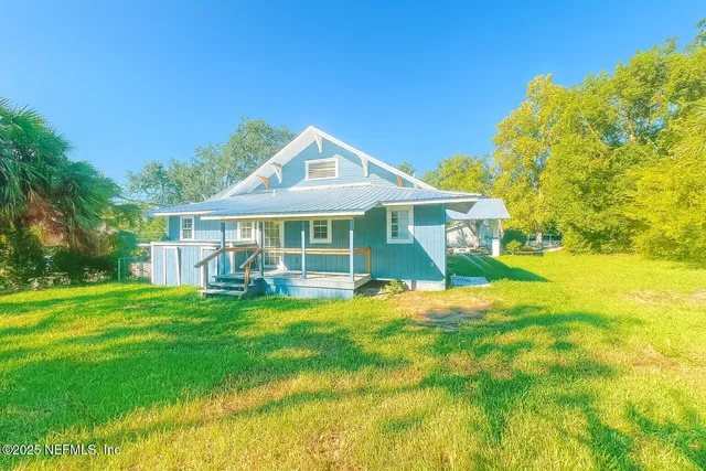 a front view of a house with swimming pool having outdoor seating