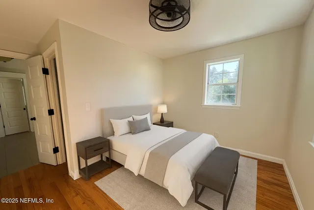 a bedroom with a bed and a window