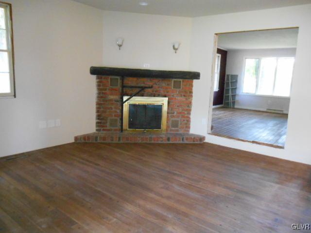277 Henry Road Nazareth, PA 18064 - Photo 3 of 14 a view of empty room with wooden floor and fireplace