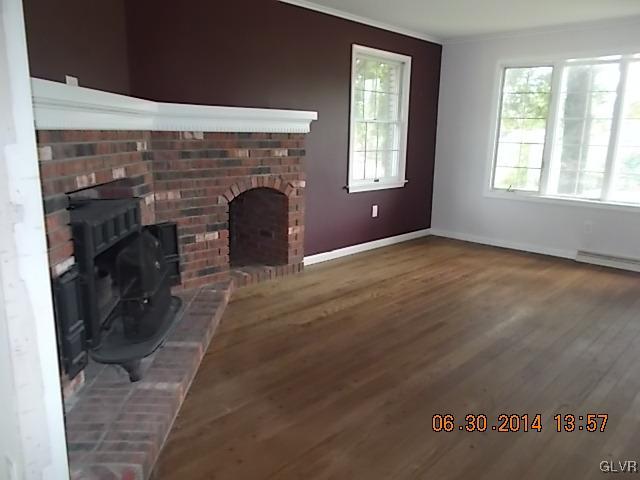 277 Henry Road Nazareth, PA 18064 - Photo 4 of 14 an empty room with windows and fireplace