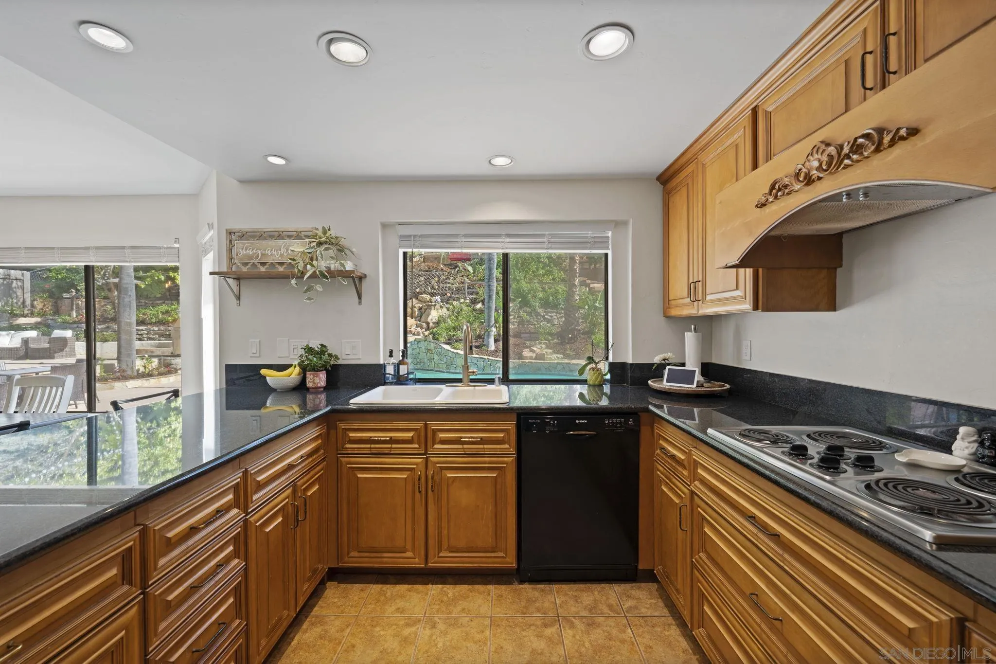 14725 Fieldview Way Poway, CA 92064 - Photo 21 of 67 a kitchen with a stove a sink a window and cabinets