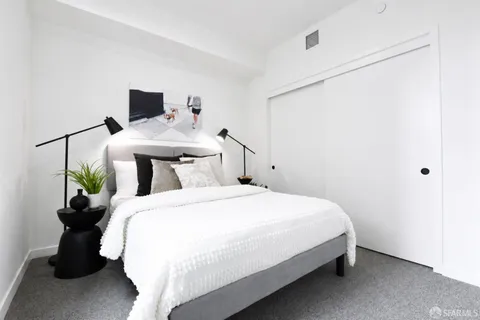 a bedroom with a bed and a potted plant