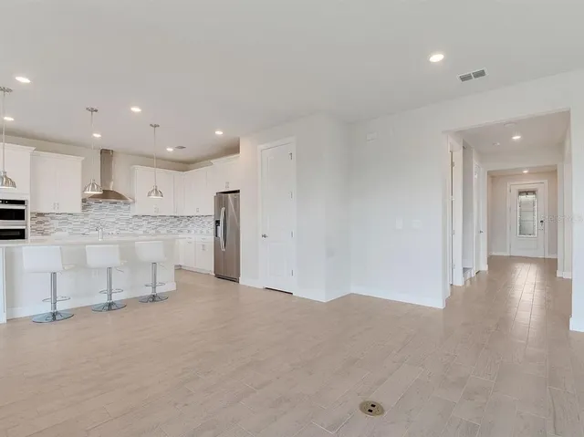 a view of kitchen with refrigerator sink and cabinets