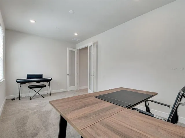 a bedroom with two beds and painting on the wall
