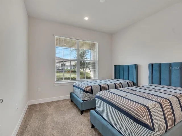 a bathroom with a shower sink vanity mirror and toilet