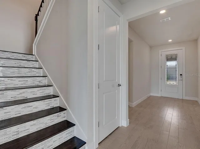 a view of a hallway with a livingroom and entryway