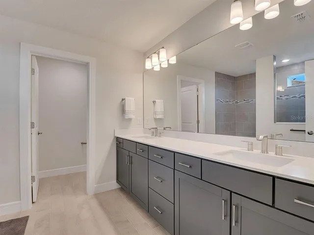 a bathroom with a shower and a sink