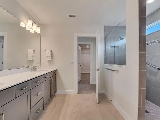 an empty room with windows and cabinet