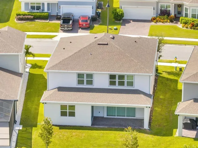 an aerial view of residential houses with outdoor space