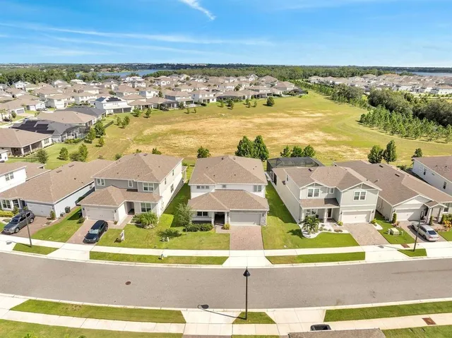 an aerial view of residential houses with outdoor space