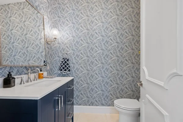 a bathroom with a granite countertop sink toilet a shower and a mirror