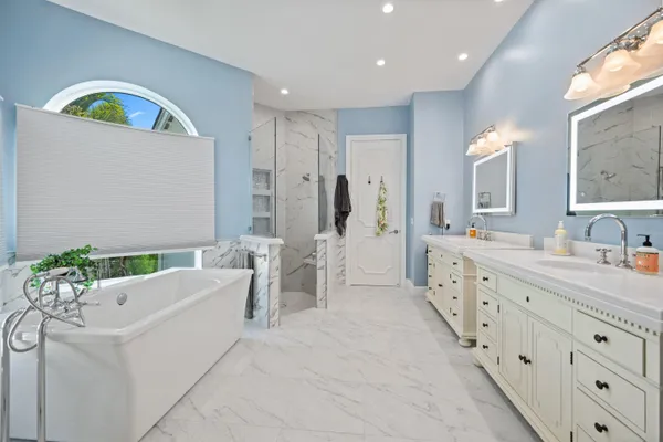 a front view of a house with swimming pool having outdoor seating