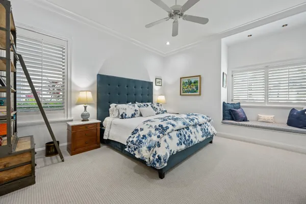 an aerial view of a house with a yard and large trees