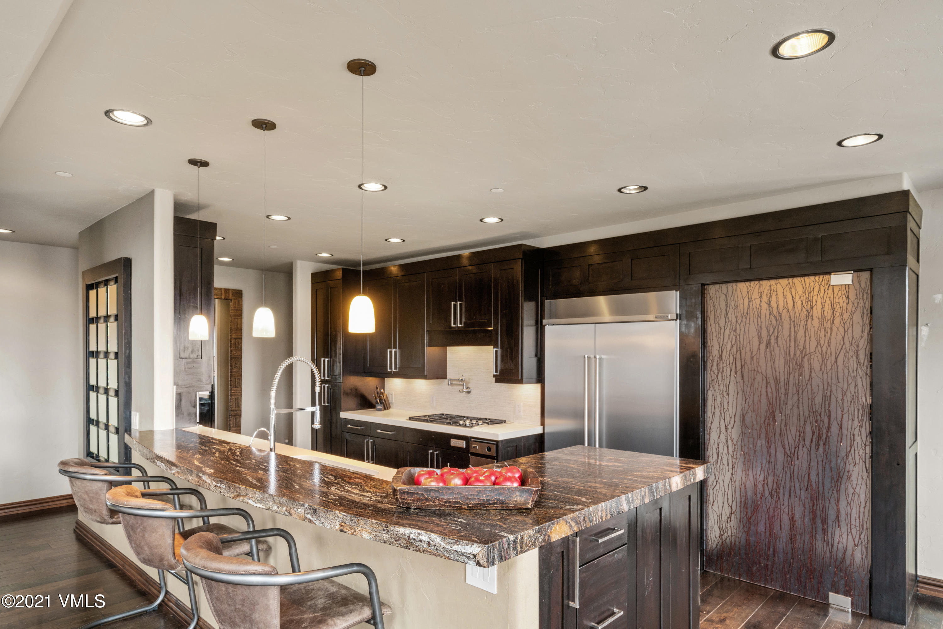 240 Casteel Ridge Edwards, CO 81632 - Photo 18 of 83 a kitchen with kitchen island granite countertop a sink and refrigerator