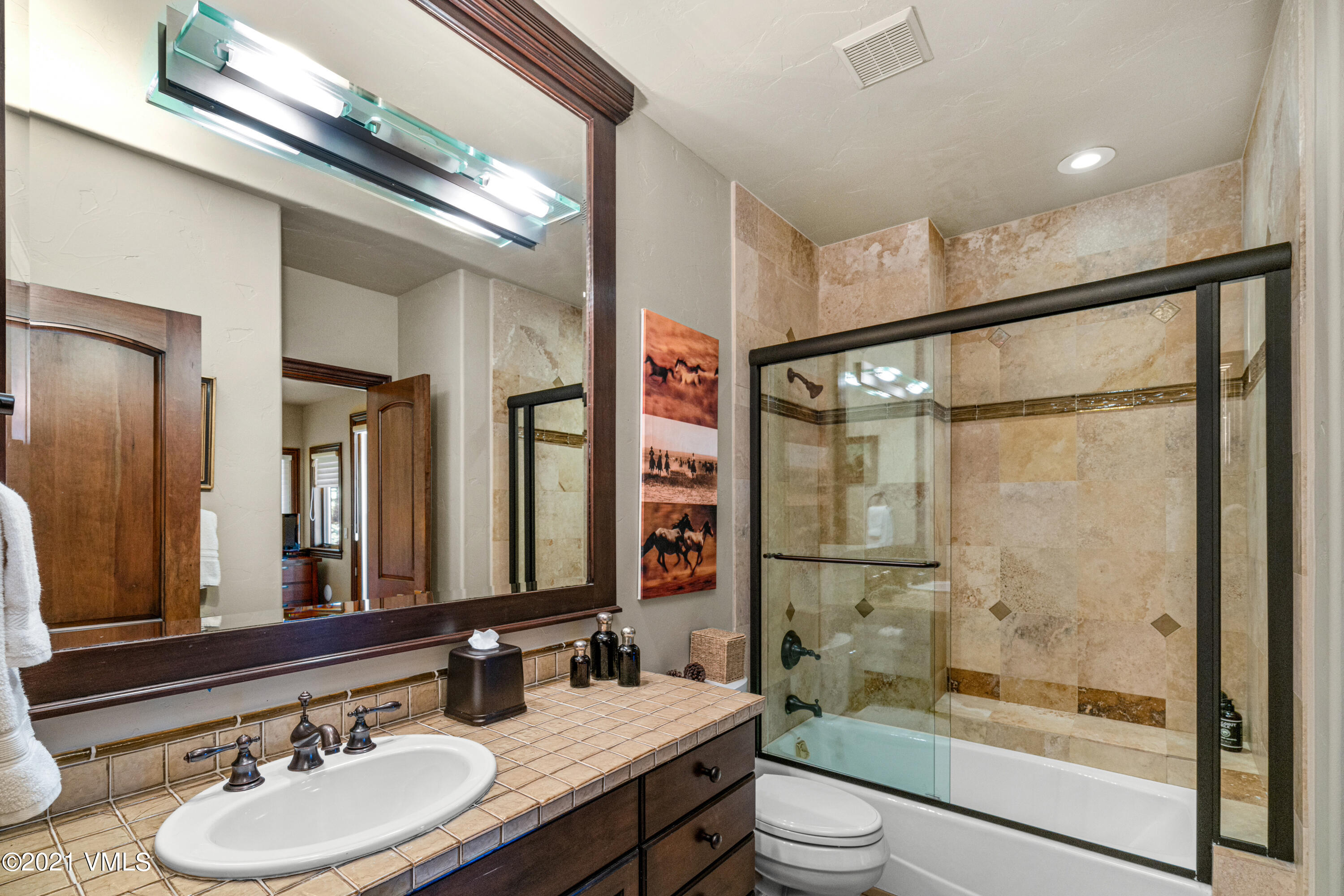 240 Casteel Ridge Edwards, CO 81632 - Photo 46 of 83 a bathroom with a granite countertop sink toilet a mirror and shower