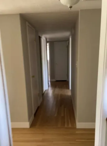 a view of gallery with wooden floor