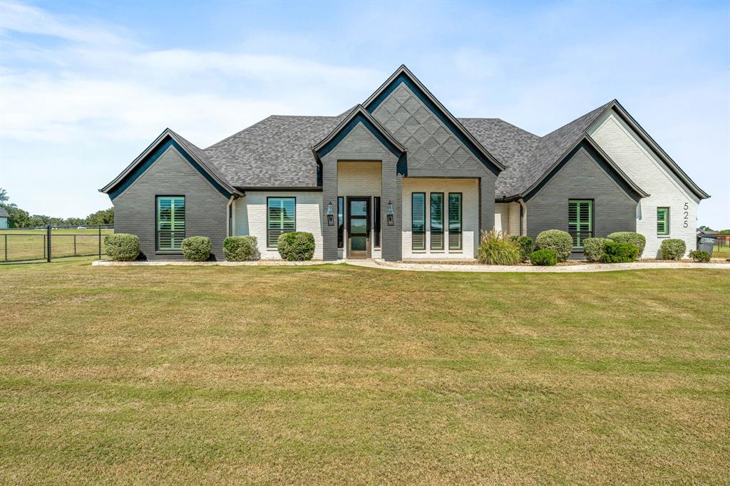 525 Ford Flats Springtown, TX 76082 - Photo 1 of 1 a front view of a house with a garden