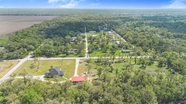 a aerial view of residential houses with outdoor space and trees
