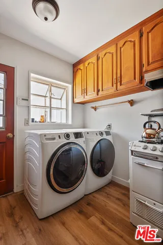 a utility room with sink dryer and washer