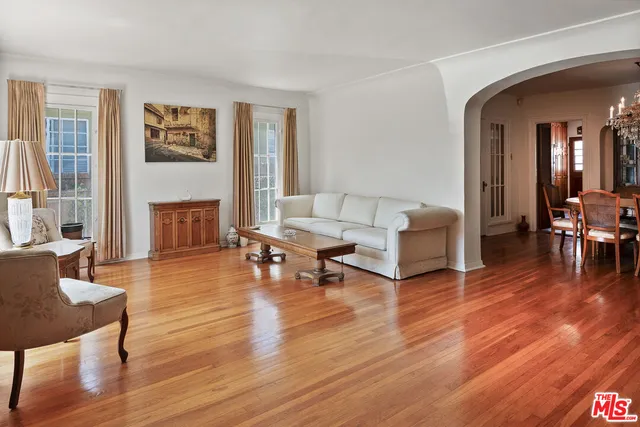 a living room with fireplace furniture and a wooden floor