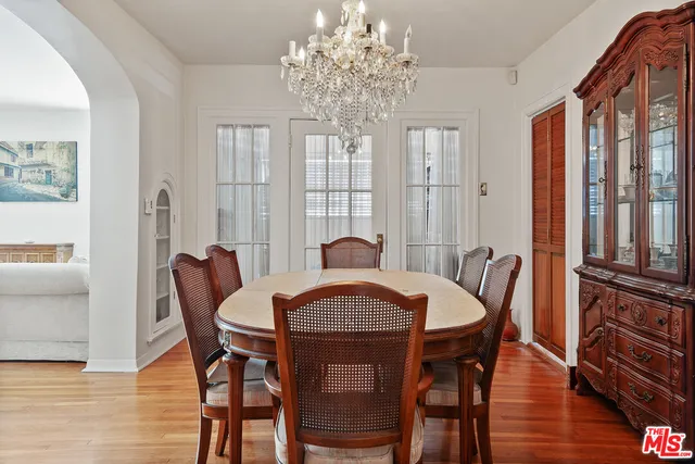 a view of a a dining room with furniture window and wooden floor
