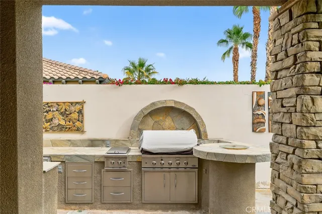 a open kitchen with stainless steel appliances kitchen island granite countertop a refrigerator and cabinets