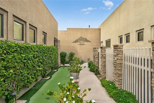 a large kitchen with kitchen island a stove a sink dishwasher and a fireplace with wooden floor