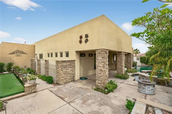 a open kitchen with stainless steel appliances granite countertop a stove top oven a refrigerator with island and chairs with wooden floor