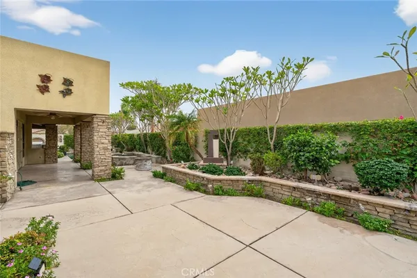 a view of an empty room with wooden floor fireplace and a window
